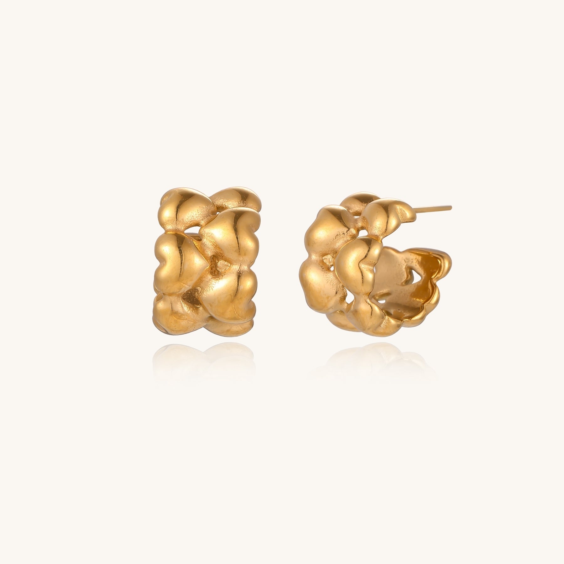 Small gold-plated hoop earrings with intricate braided texture pattern and post backs on white background.